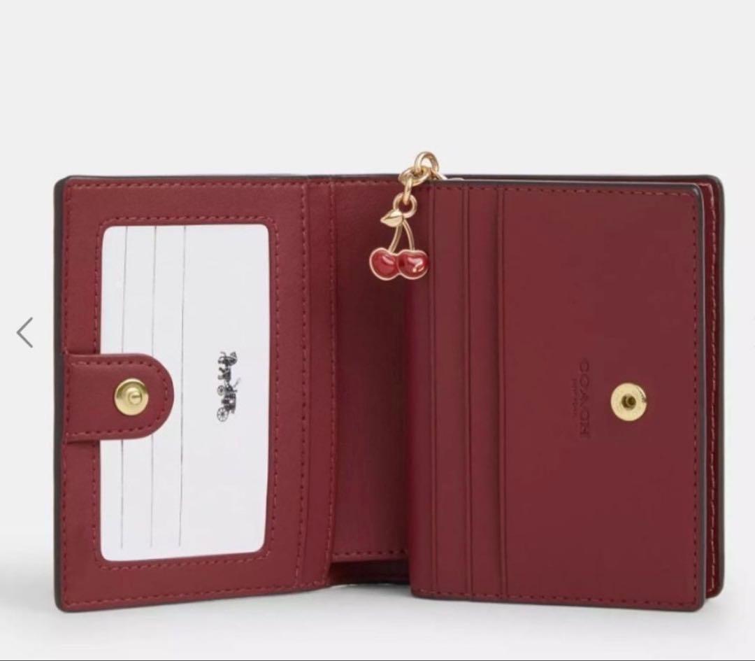 COACH シグネチャーチェリープリント二つ折り財布、さくらん