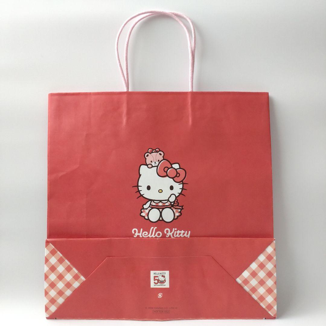 キティ 50周年記念カフェ 缶バッジ 巾着 ステッカー ショッパー